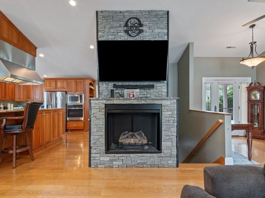 Fireplace, Interior, Kitchen, Pendant Lights, Recessed Lighting, Stainless Steel Appliances, Stone Walls, Wood Texture Flooring
