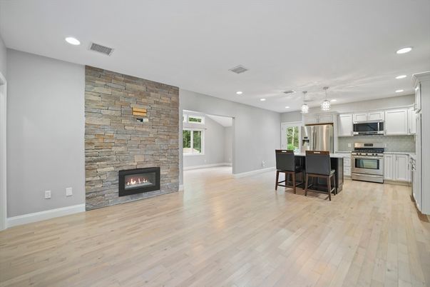 Dining room, Fireplace, Interior, Kitchen, Pendant Lights, Recessed Lighting, Stainless Steel Appliances, Stone Walls, Wood Texture Flooring