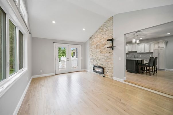 Chandelier, Dining room, Empty room, Fireplace, Interior, Kitchen, Recessed Lighting, Stone Walls, Wood Texture Flooring