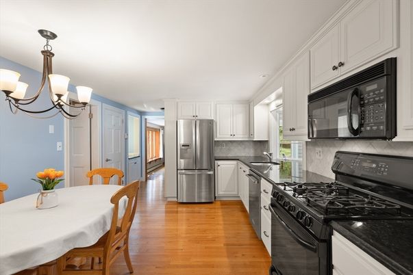 Chandelier, Dining room, Interior, Kitchen, Recessed Lighting, Stainless Steel Appliances, Wood Texture Flooring