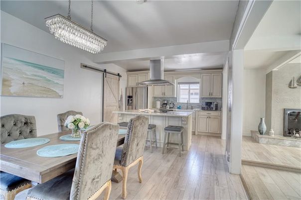 Chandelier, Dining room, Fireplace, Interior, Kitchen, Stainless Steel Appliances, Wood Texture Flooring