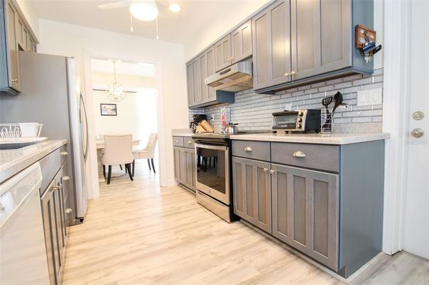 Interior, Kitchen, Wood Texture Flooring, Dining room, Chandelier, Stainless Steel Appliances