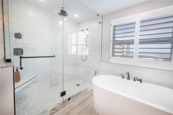 Bathroom, Free Standing Baths, Glass Shower, Interior, Marble Walls, Recessed Lighting, Wood Texture Flooring