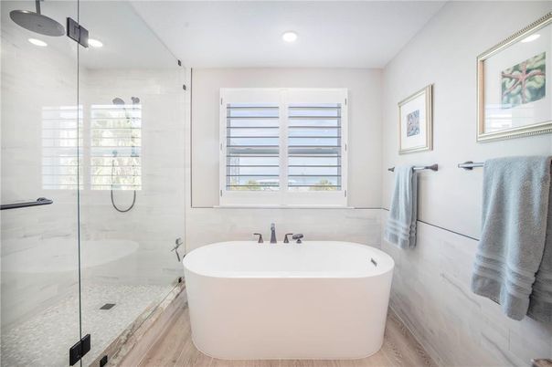 Bathroom, Free Standing Baths, Glass Shower, Interior, Marble Walls, Recessed Lighting, Wood Texture Flooring