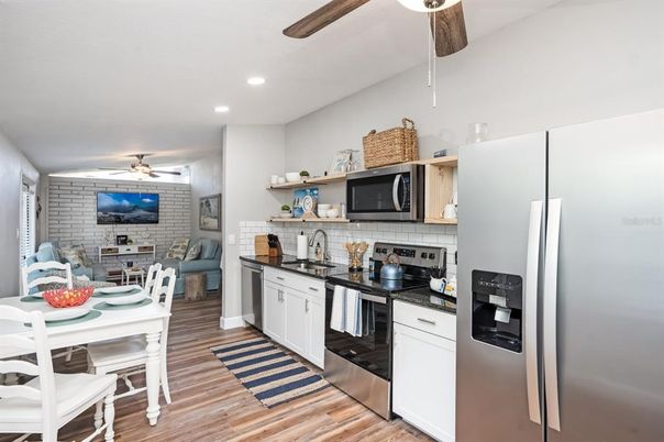 Dining room, Interior, Kitchen, Recessed Lighting, Stainless Steel Appliances, Stone Walls, Wood Texture Flooring
