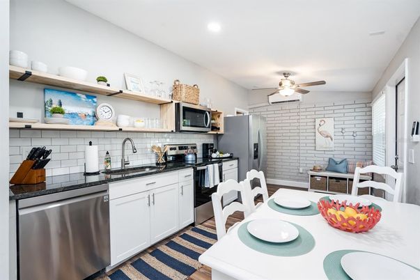 Dining room, Interior, Kitchen, Recessed Lighting, Stainless Steel Appliances, Stone Walls, Wood Texture Flooring