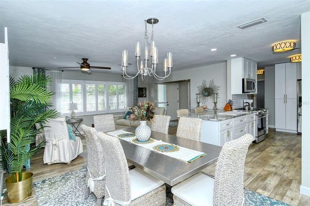 Chandelier, Dining room, Interior, Kitchen, Living room, Recessed Lighting, Stainless Steel Appliances, Wood Texture Flooring