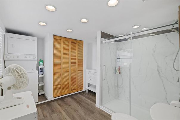 Bathroom, Glass Shower, Interior, Marble Walls, Recessed Lighting, Wood Texture Flooring