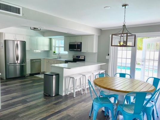Dining room, Interior, Kitchen, Pendant Lights, Stainless Steel Appliances, Wood Texture Flooring
