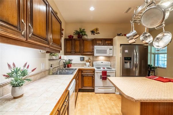 Interior, Kitchen, Recessed Lighting, Stainless Steel Appliances, Tile Countertops, Wood Texture Flooring