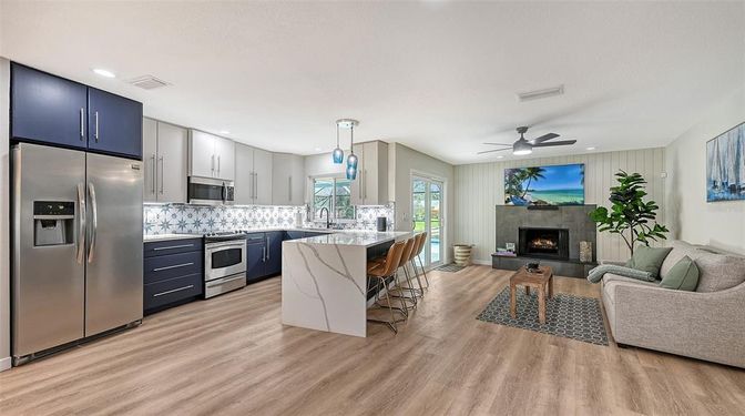 Fireplace, Interior, Kitchen, Living room, Pendant Lights, Recessed Lighting, Stainless Steel Appliances, Wood Texture Flooring