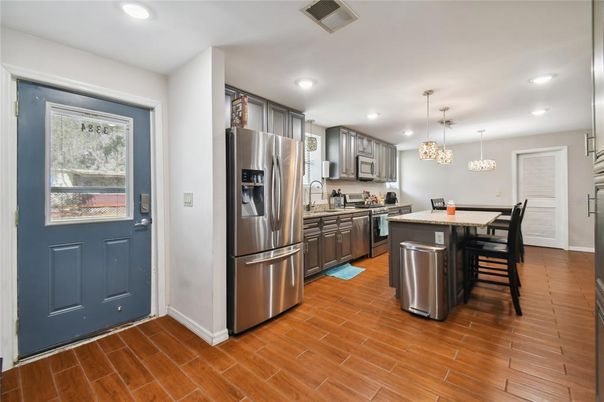 Chandelier, Dining room, Interior, Kitchen, Pendant Lights, Recessed Lighting, Stainless Steel Appliances, Wood Texture Flooring