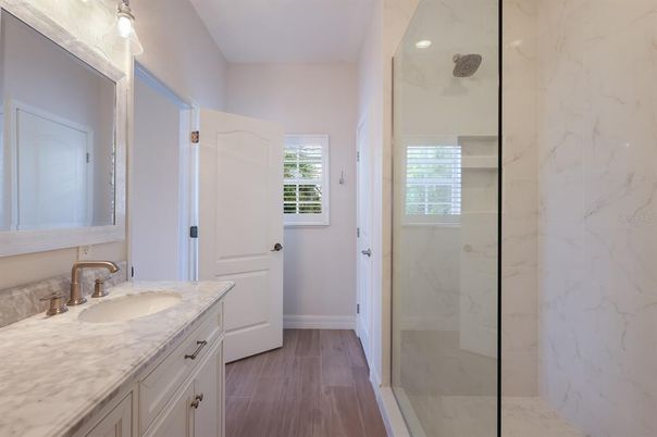 Bathroom, Glass Shower, Interior, Marble Walls, Recessed Lighting, Wood Texture Flooring