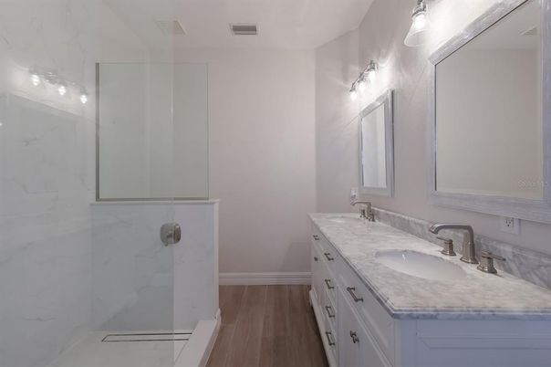 Bathroom, Dual Sink Vanities, Glass Shower, Interior, Marble Walls, Wood Texture Flooring