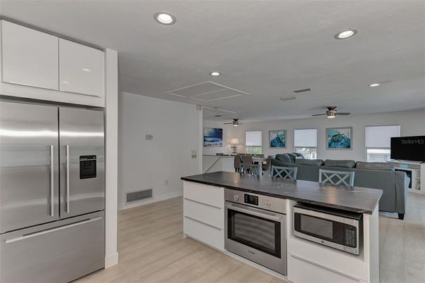 Dining room, Interior, Kitchen, Living room, Recessed Lighting, Stainless Steel Appliances, Wood Texture Flooring