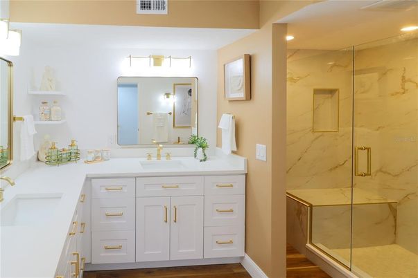 Bathroom, Dual Sink Vanities, Glass Shower, Interior, Marble Walls, Recessed Lighting, Wood Texture Flooring