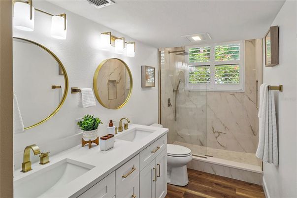 Bathroom, Dual Sink Vanities, Glass Shower, Interior, Marble Walls, Recessed Lighting, Wood Texture Flooring