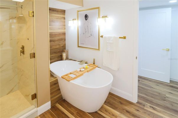 Bathroom, Free Standing Baths, Glass Shower, Interior, Marble Walls, Recessed Lighting, Wood Texture Flooring