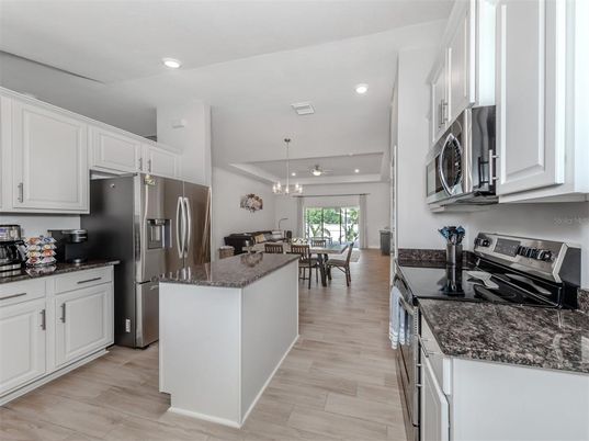 Chandelier, Dining room, Interior, Kitchen, Pendant Lights, Recessed Lighting, Stainless Steel Appliances, Wood Texture Flooring