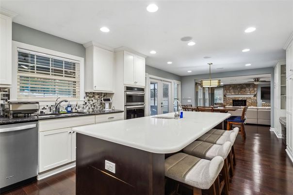 Fireplace, Interior, Kitchen, Pendant Lights, Recessed Lighting, Stainless Steel Appliances, Stone Walls, Wood Texture Flooring