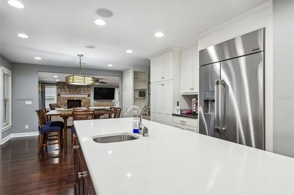 Dining room, Fireplace, Interior, Kitchen, Pendant Lights, Recessed Lighting, Stainless Steel Appliances, Stone Walls, Wood Texture Flooring