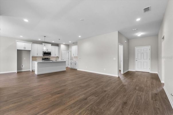 Empty room, Interior, Kitchen, Pendant Lights, Recessed Lighting, Stainless Steel Appliances, Wood Texture Flooring