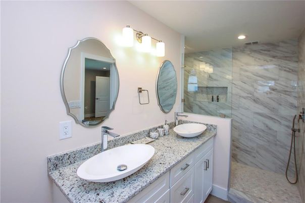 Bathroom, Dual Sink Vanities, Glass Shower, Interior, Marble Walls, Recessed Lighting
