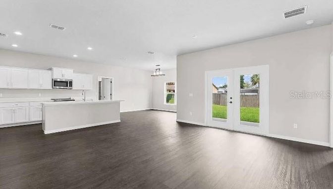 Empty room, Interior, Kitchen, Pendant Lights, Recessed Lighting, Stainless Steel Appliances, Wood Texture Flooring