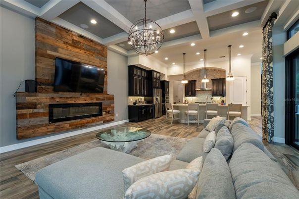 Chandelier, Dining room, Fireplace, Interior, Kitchen, Living room, Pendant Lights, Recessed Lighting, Wood Texture Flooring, Wooden Walls