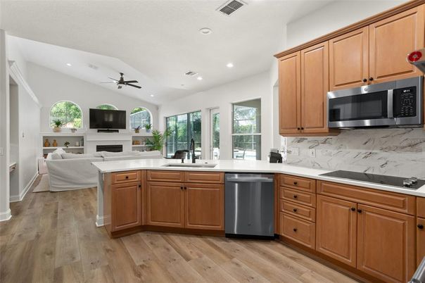 Fireplace, Interior, Kitchen, Living room, Recessed Lighting, Stainless Steel Appliances, Wood Texture Flooring