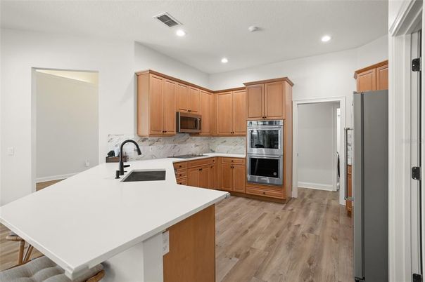 Interior, Kitchen, Recessed Lighting, Stainless Steel Appliances, Wood Texture Flooring