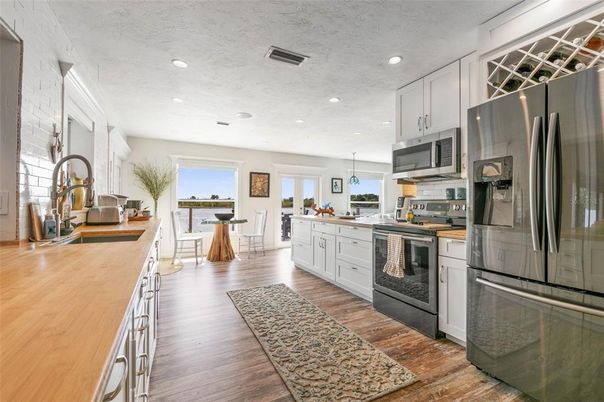 Dining room, Interior, Kitchen, Pendant Lights, Recessed Lighting, Stainless Steel Appliances, Wood Texture Flooring