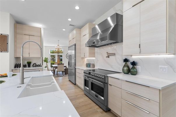 Chandelier, Dining room, Interior, Kitchen, Marble Walls, Recessed Lighting, Stainless Steel Appliances, Wood Texture Flooring