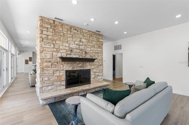 Fireplace, Interior, Living room, Recessed Lighting, Stone Walls, Wood Texture Flooring