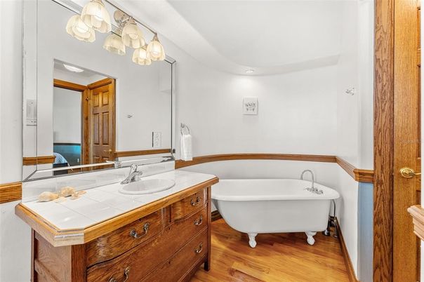 Bathroom, Dual Sink Vanities, Free Standing Baths, Interior, Recessed Lighting, Tile Countertops, Wood Texture Flooring