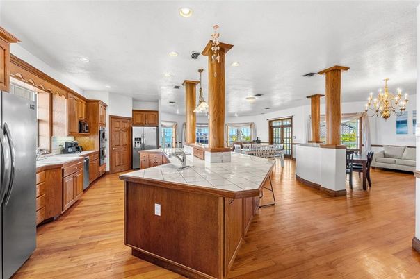 Chandelier, Interior, Kitchen, Living room, Pendant Lights, Recessed Lighting, Stainless Steel Appliances, Tile Countertops, Wood Texture Flooring