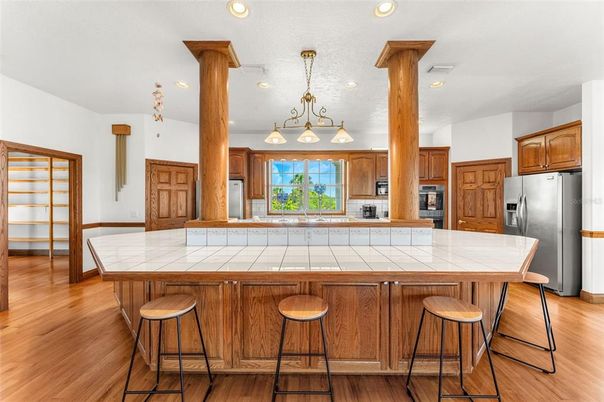 Interior, Kitchen, Pendant Lights, Recessed Lighting, Stainless Steel Appliances, Tile Countertops, Wood Texture Flooring