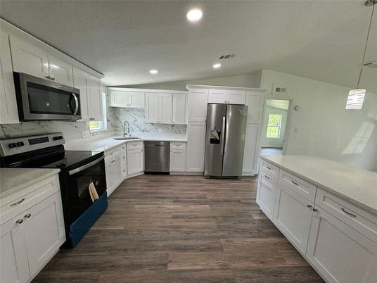 Interior, Kitchen, Marble Walls, Recessed Lighting, Stainless Steel Appliances, Wood Texture Flooring