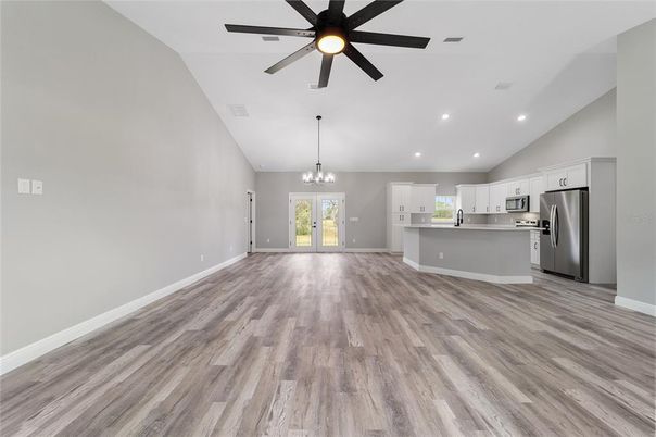 Chandelier, Empty room, Interior, Kitchen, Recessed Lighting, Stainless Steel Appliances, Wood Texture Flooring