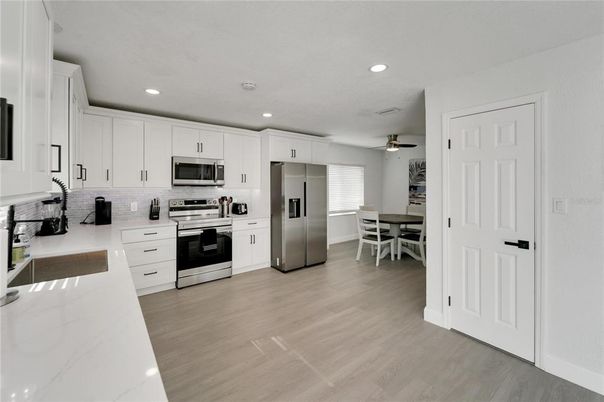 Dining room, Interior, Kitchen, Recessed Lighting, Stainless Steel Appliances, Wood Texture Flooring