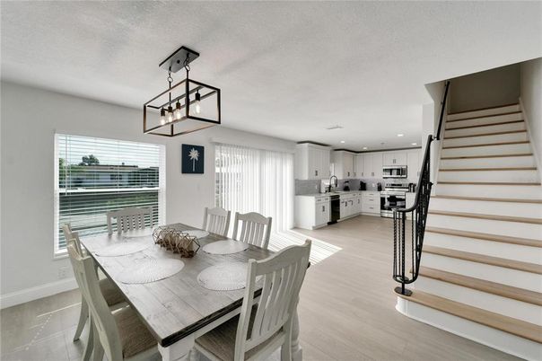 Dining room, Interior, Kitchen, Pendant Lights, Recessed Lighting, Stainless Steel Appliances, Wood Texture Flooring