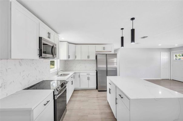 Interior, Kitchen, Marble Walls, Recessed Lighting, Stainless Steel Appliances, Wood Texture Flooring
