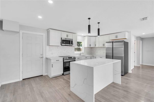 Interior, Kitchen, Marble Walls, Recessed Lighting, Stainless Steel Appliances, Wood Texture Flooring