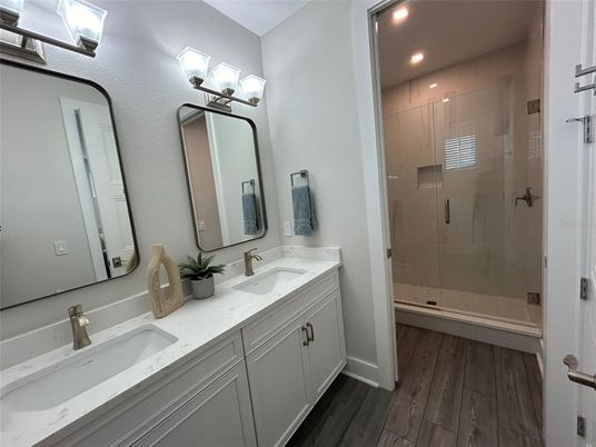 Bathroom, Dual Sink Vanities, Glass Shower, Interior, Recessed Lighting, Wood Texture Flooring