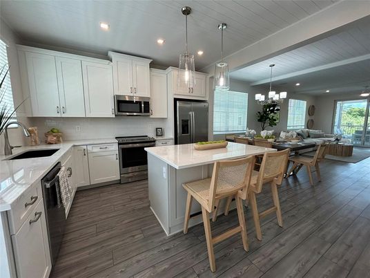 Chandelier, Dining room, Interior, Kitchen, Living room, Pendant Lights, Recessed Lighting, Stainless Steel Appliances, Wood Texture Flooring
