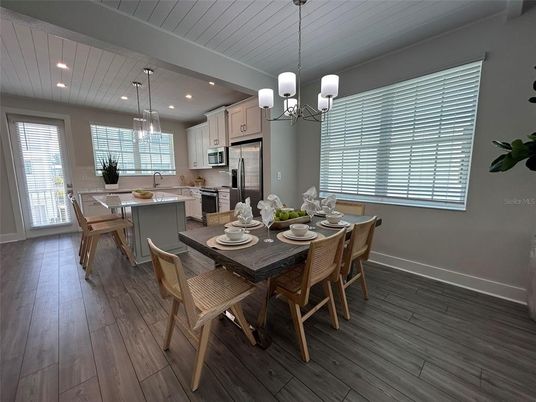 Chandelier, Dining room, Interior, Kitchen, Pendant Lights, Recessed Lighting, Stainless Steel Appliances, Wood Texture Flooring