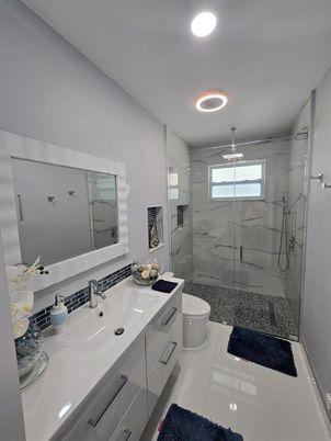 Bathroom, Dual Sink Vanities, Glass Shower, Interior, Marble Walls, Recessed Lighting