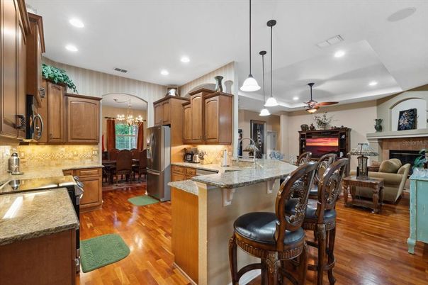 Chandelier, Dining room, Fireplace, Interior, Kitchen, Living room, Pendant Lights, Recessed Lighting, Wood Texture Flooring