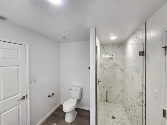Bathroom, Glass Shower, Interior, Marble Walls, Recessed Lighting, Wood Texture Flooring