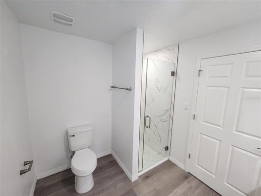 Bathroom, Glass Shower, Interior, Marble Walls, Wood Texture Flooring
